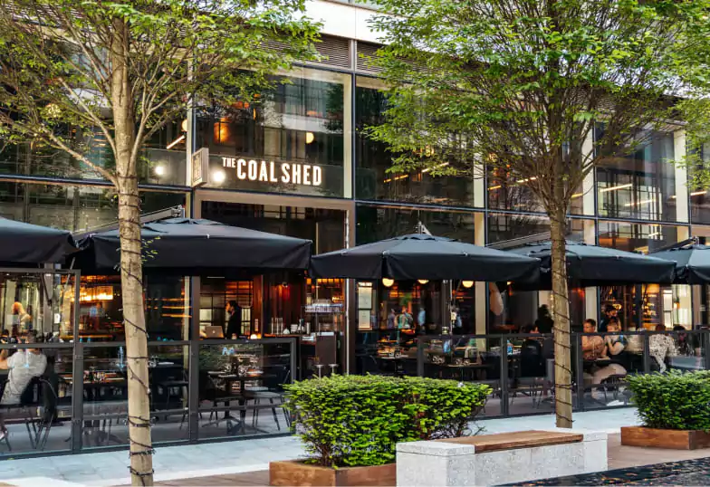 A stylish steakhouse with a contemporary glass exterior and cozy outdoor seating, a great spot for meat lovers to discover with Ambl.