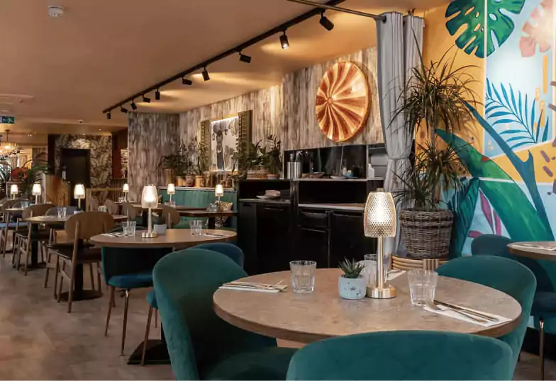 A lively Caribbean restaurant with tropical decor, bold colors, and a warm, inviting atmosphere, a must-visit find on Ambl.