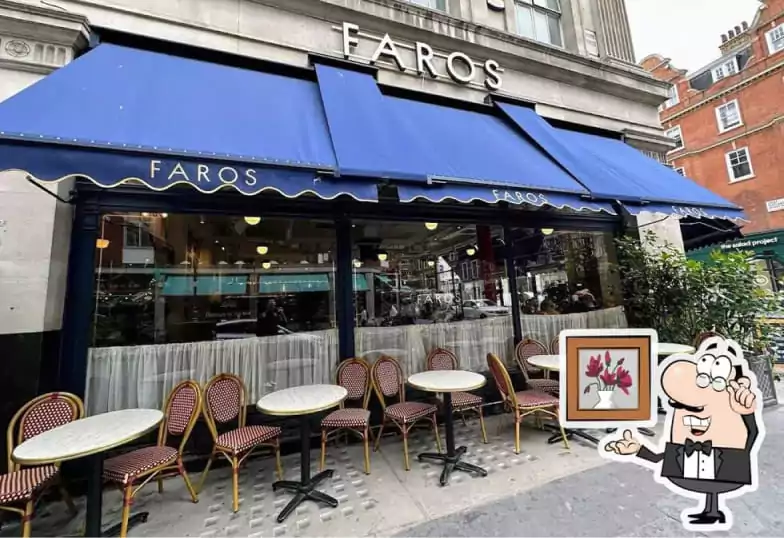 A stylish European bistro with a navy blue facade, classic rattan chairs, and an elegant terrace. The inviting atmosphere makes it an ideal spot for relaxed dining. Find more European-inspired restaurants on Ambl.