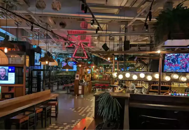 A stylish sports bar with a mix of high stools and lounge seating, large-screen TVs, and a lively atmosphere. Perfect for catching the game. Explore more sports bars on Ambl.