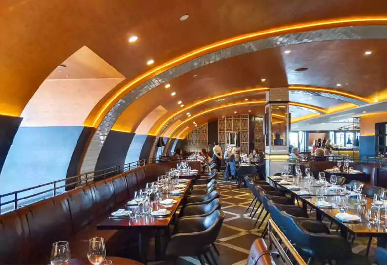 A beautifully designed Spanish restaurant with arched ceilings, ambient lighting, and elegant dining tables. Discover the finest Spanish cuisine in London with Ambl.