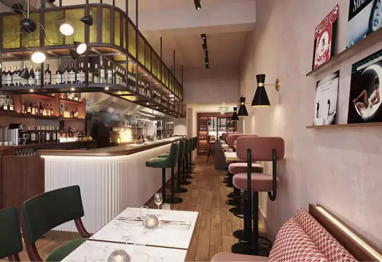 A modern and intimate bar at Caia, with stylish seating, warm lighting, and vinyl records decorating the walls. Enjoy a refined night out with Ambl.