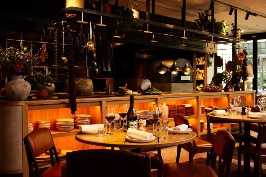 Signature dishes cooked on a wood-fired grill including fresh fish, steaks, arroces and vegetables.