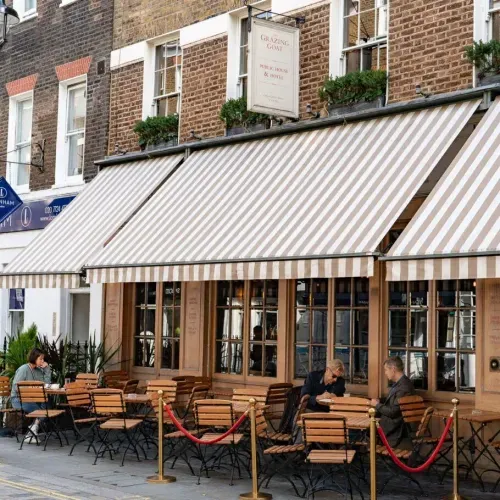 The Grazing Goat: Traditional London gastropub with wooden bar, craft beer taps, and plates of British pub food.