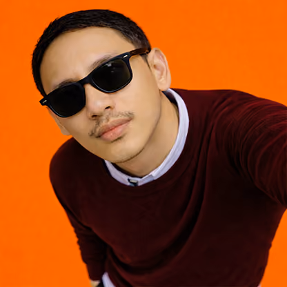Man wearing dark sunglasses and maroon sweater against bright orange background