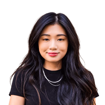 Young woman with long black hair and pink lipstick wearing black shirt and silver necklace