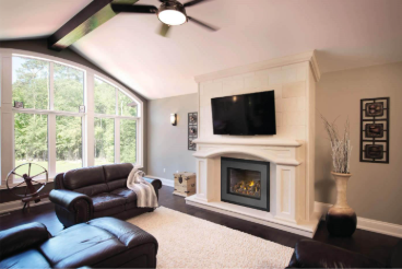 A living room with a fireplace and a ceiling fanAI-generated content may be incorrect.
