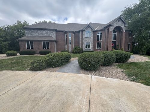 Neatly trimmed shrubs along the front of a home in Grain Valley, MO serviced by Marrs Lawn and Landscape