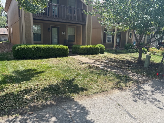 Bush trimming clippings on the ground during a full-service cleanup and haul-away by Marrs Lawn and Landscape in Grain Valley, MO