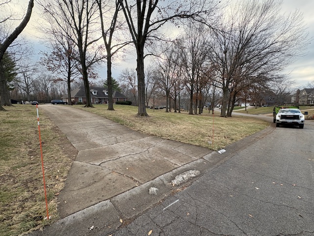 Marrs Lawn and Landscape trailer-mounted leaf vacuum parked at curb after hauling leaves from a Grain Valley, MO property