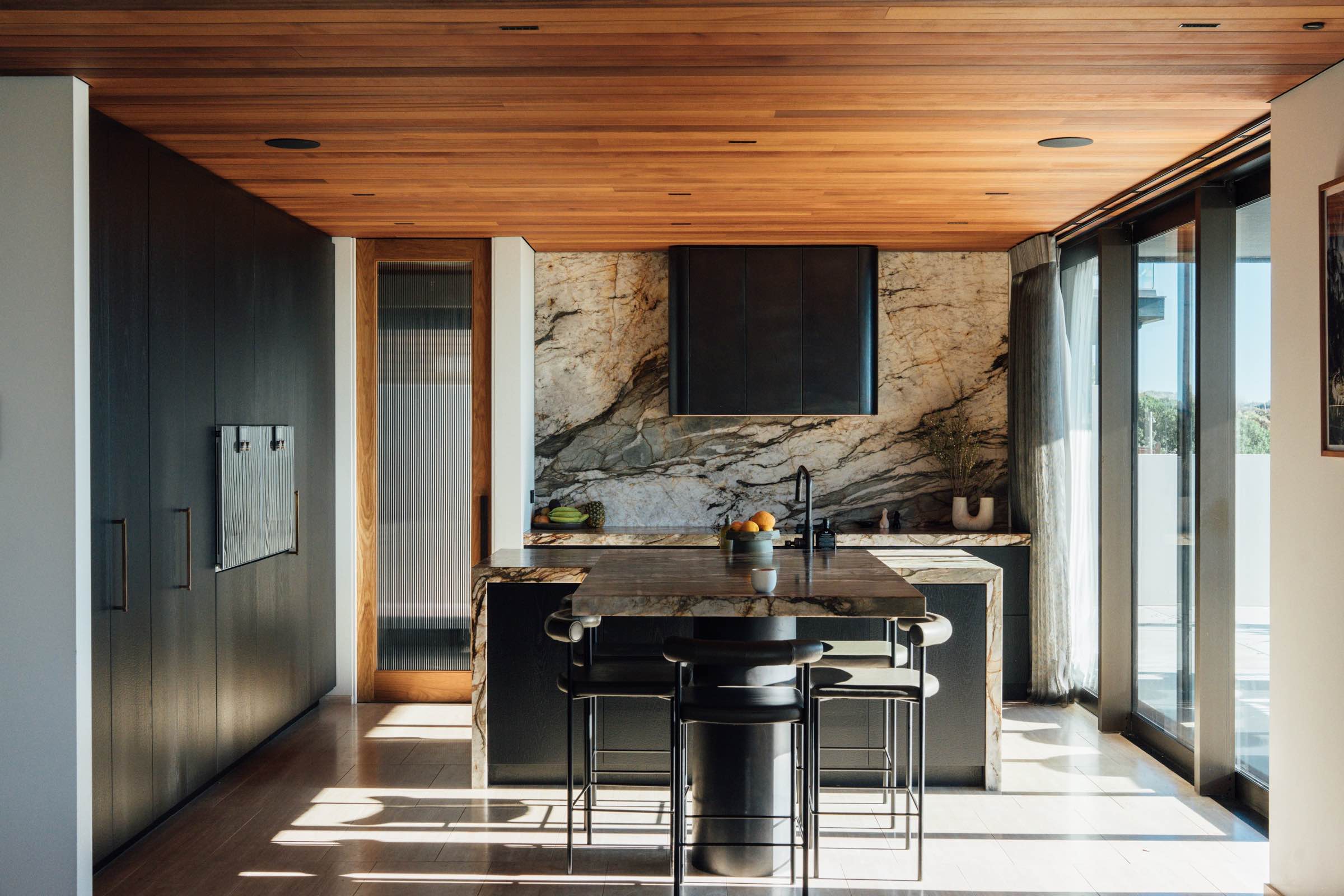 Renovated open-plan kitchen with marble island and oak joinery