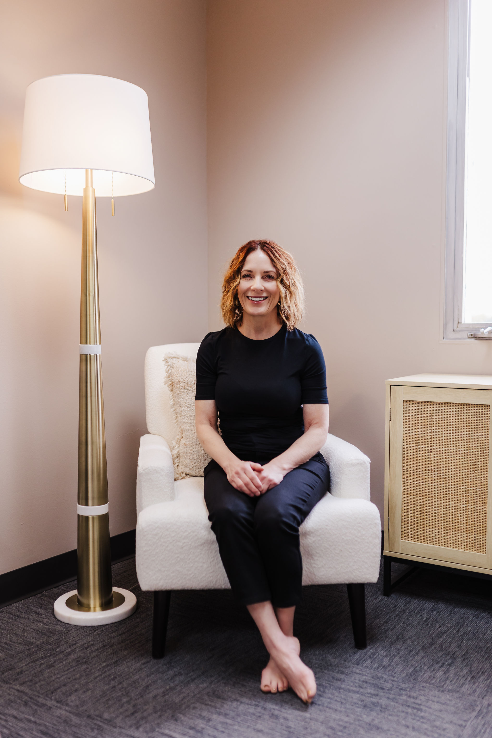 image of Deb sitting in a chair