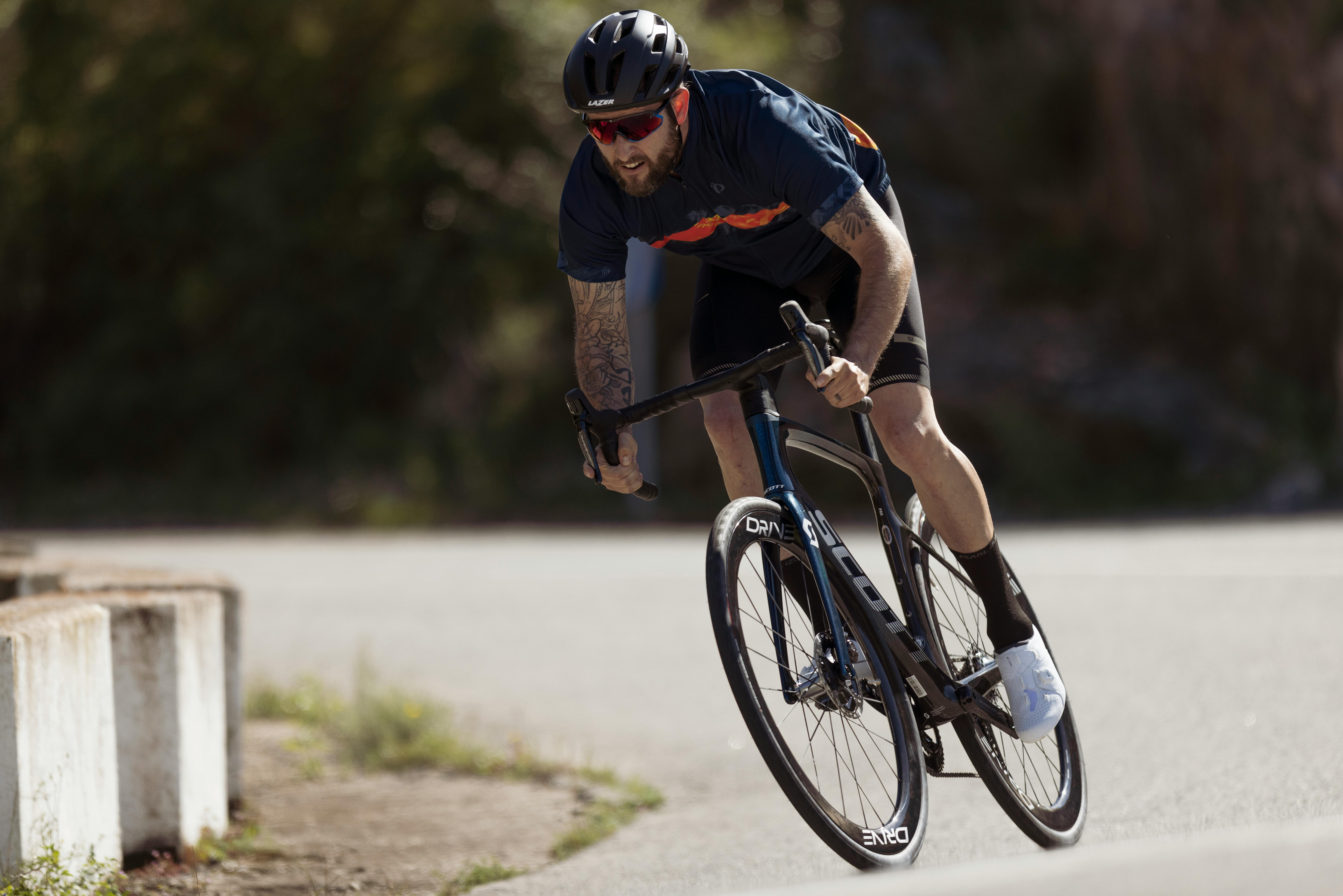 Cyclist holding a riding position with visible neck extension and shoulder stabilisation.