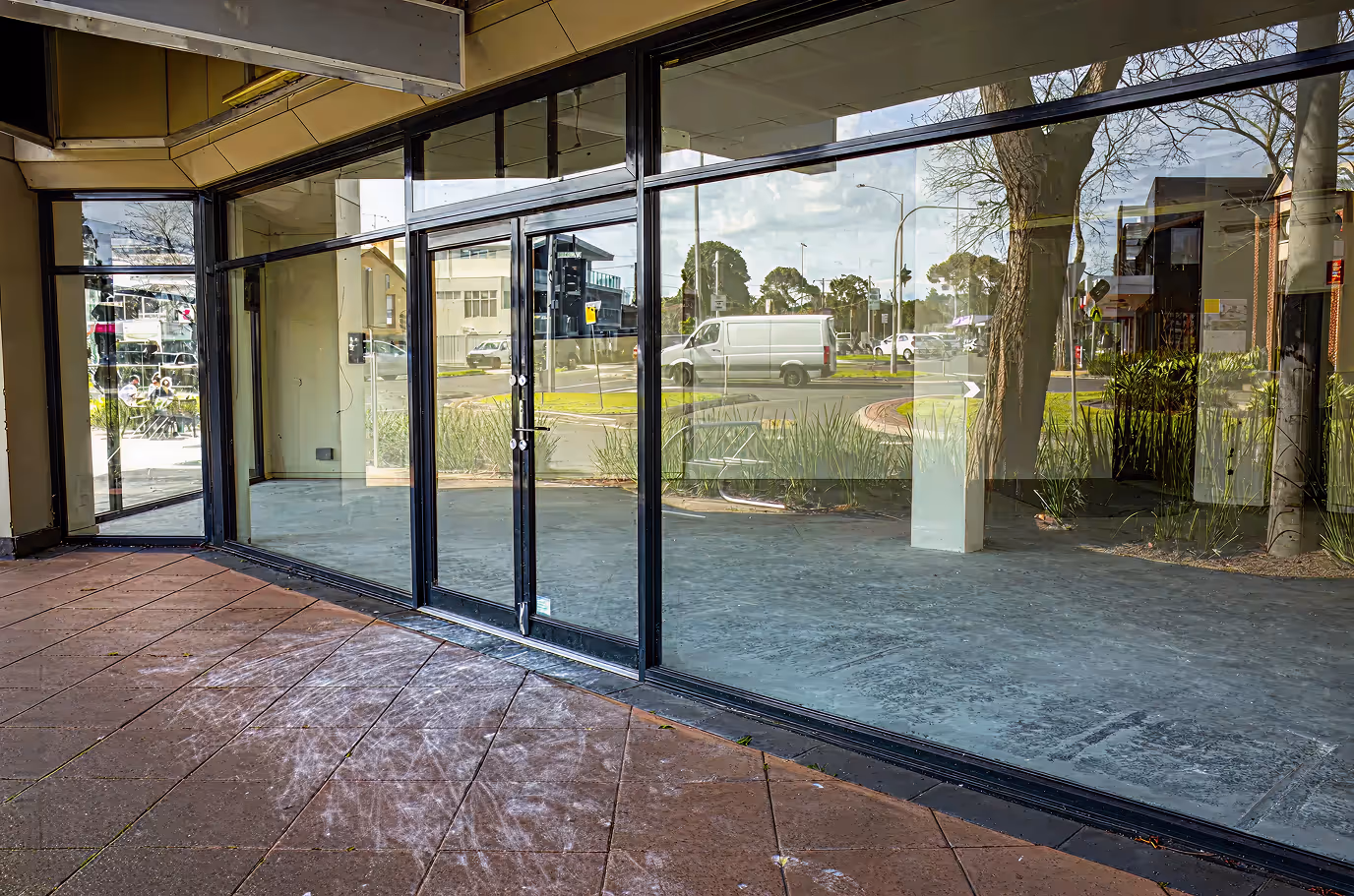 Sliding impact glass doors Miami storefront entrance