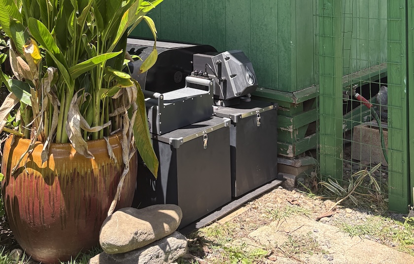 Mata installed on stone pavers between a post and pier home and a flower pot.