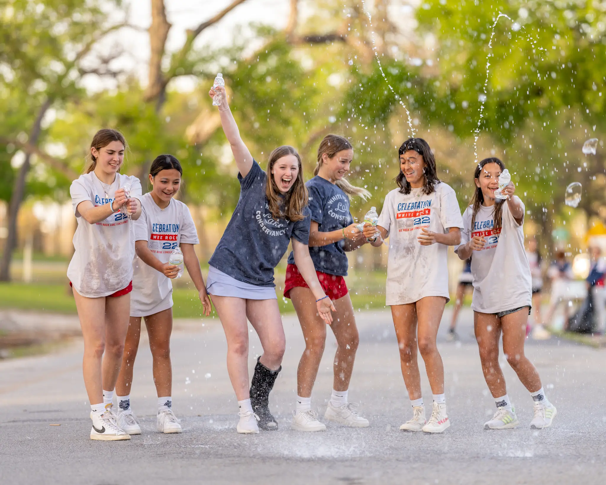 Group of six young people having fun at Celebration White Rock race in Dallas, TX.
