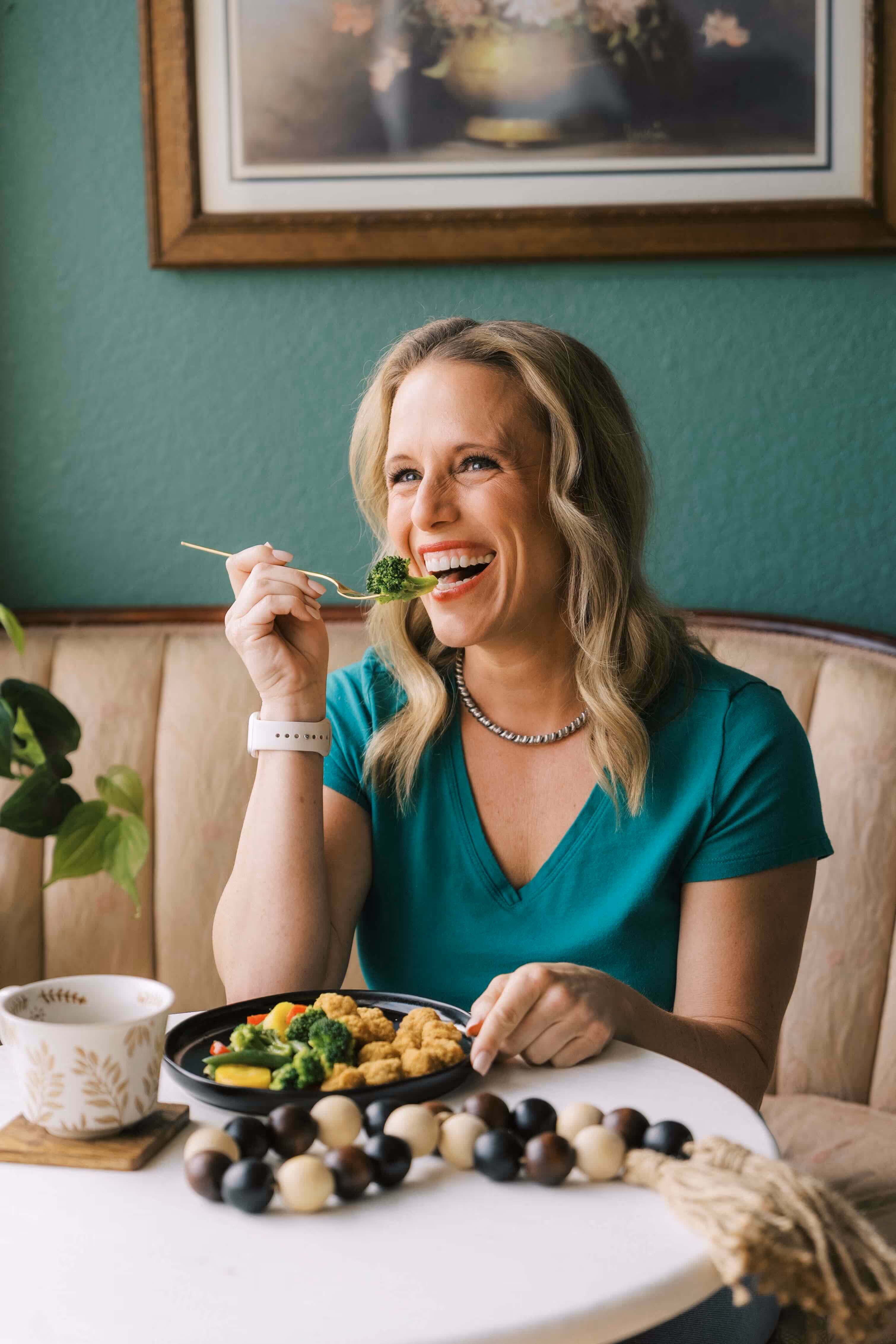 a woman smiling and editing a healthy weight loss meal from personal trainer food