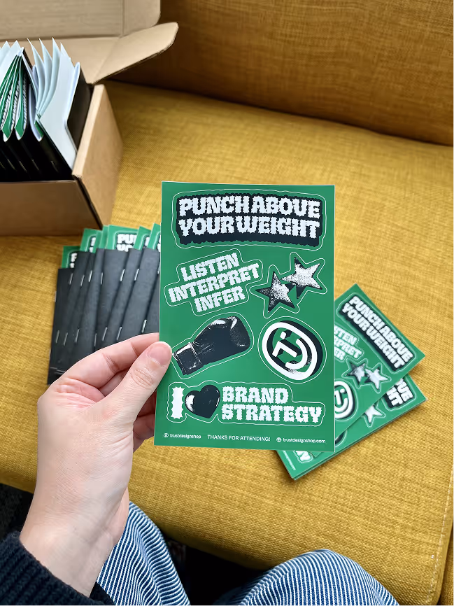 Our Punch Above Your Weight sticker packs, with various illustrations and badges.