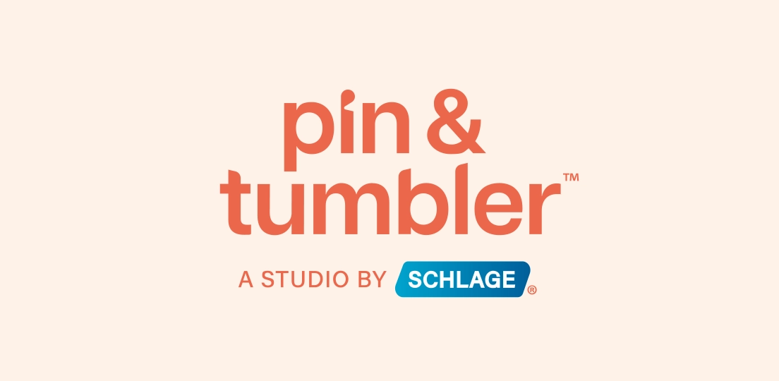 Logo of pin & tumbler, a studio by Schlage, with text in orange and blue on a peachy background.