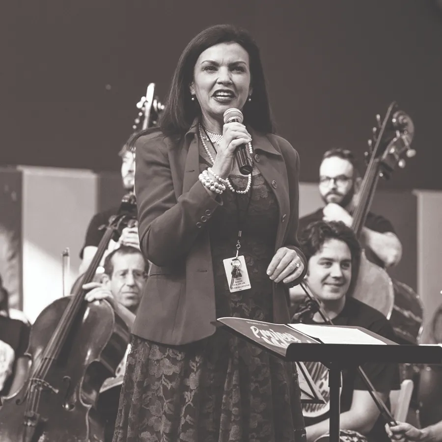 Musician playing cello during a community performance