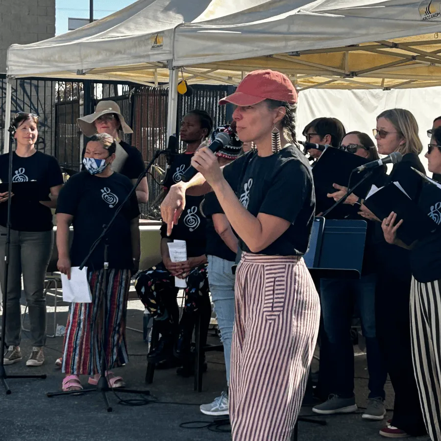 Group of musicians performing outdoors under a canopy