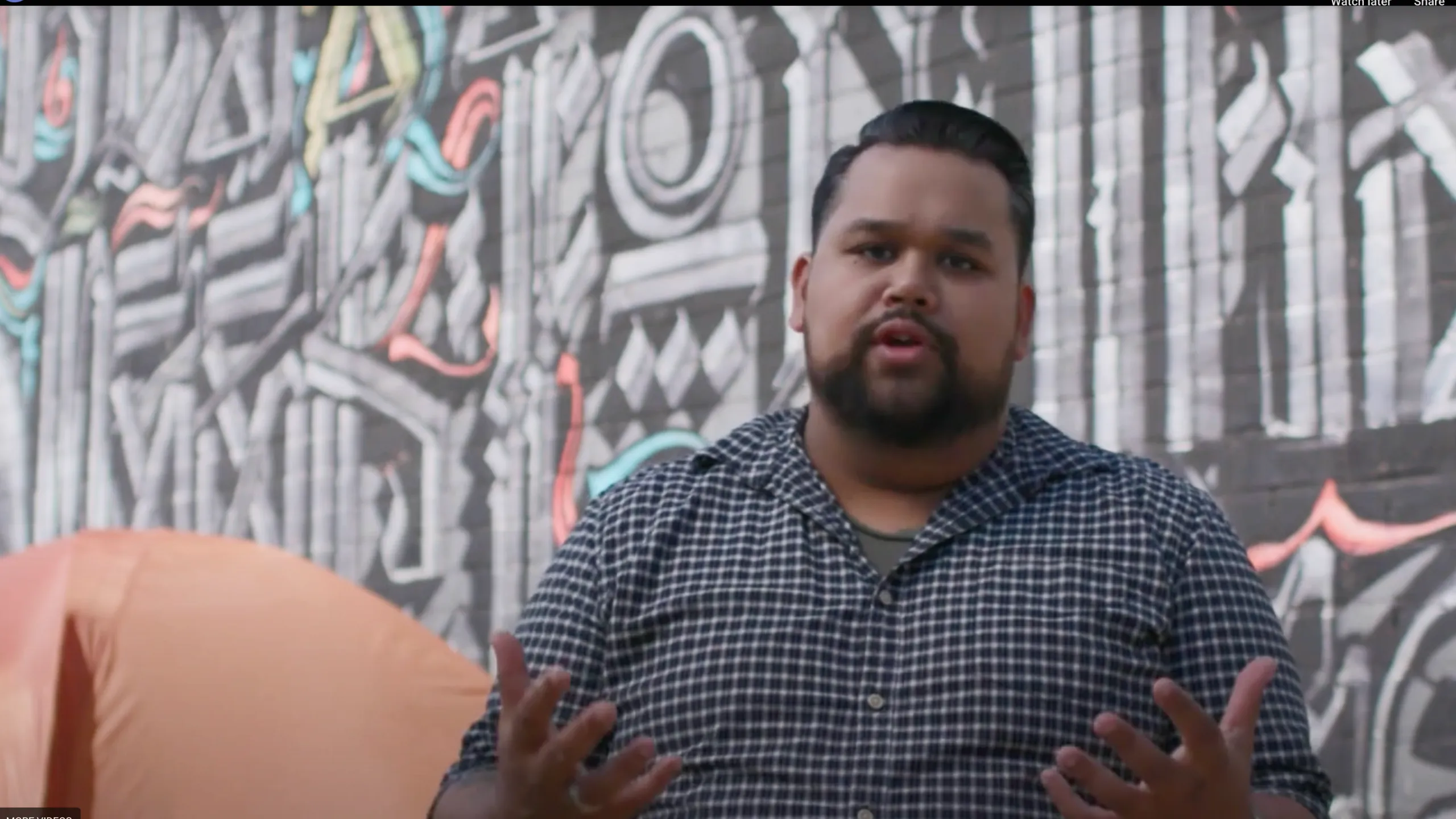 Vijay Gupta speaking into a microphone during a presentation