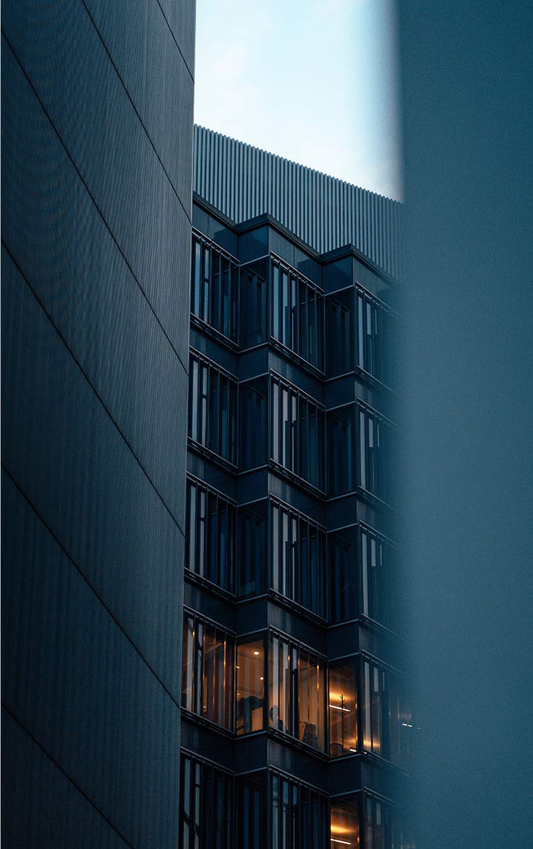 View to the facade of an apartment building with light in one window