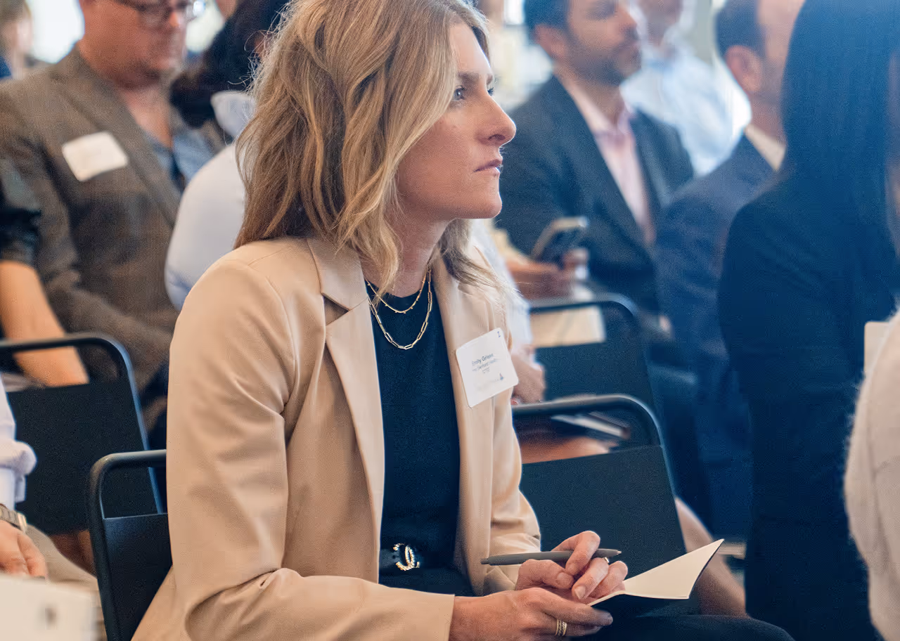 SimerVirens professional woman attending conference, taking notes attentively