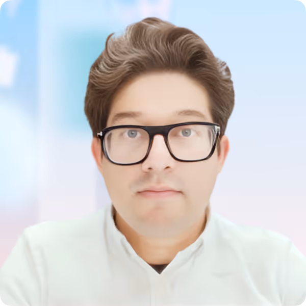 Man with short brown hair and black glasses wearing a white shirt against a blurred blue and pink background.