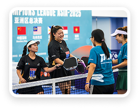 Four female tennis players shaking hands and smiling at the net after a match, with a Champions League Asia 2023 banner in the background.