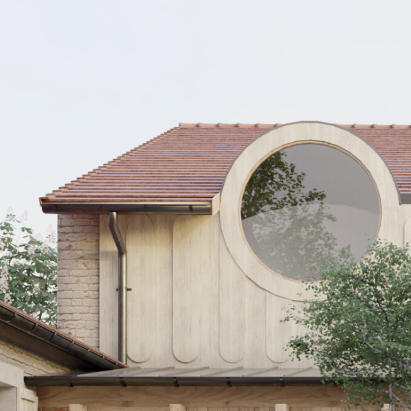 Modern courtyard with green grass, wildflowers, a central young tree, and a two-story brick and cream building featuring large round windows.