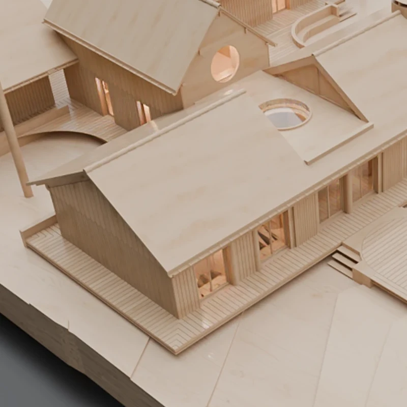 Architectural wooden model of a complex with multiple buildings, walkways, and a water channel on a terrain base.