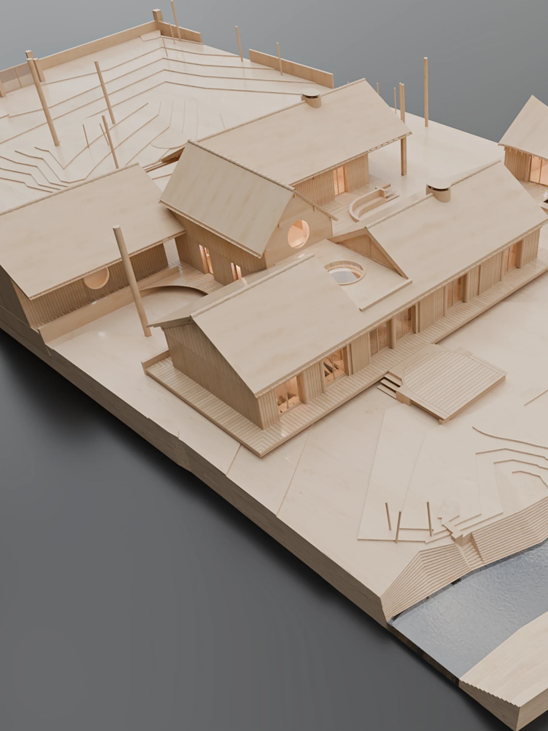 Wooden architectural model of a complex with several buildings, terraces, and a stream running alongside.