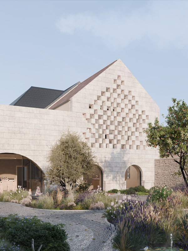 Modern stone building with a textured triangular facade, arched entrances, and lush garden with trees and flowering plants in front.