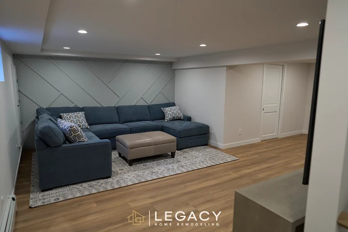 Legacy Home Remodleing  Finished basement living room with gray sectional sofa.