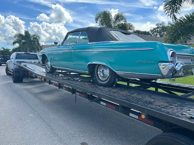 Ultimate Transport 123 Classic turquoise convertible car on transport trailer nationwide across the U.S.