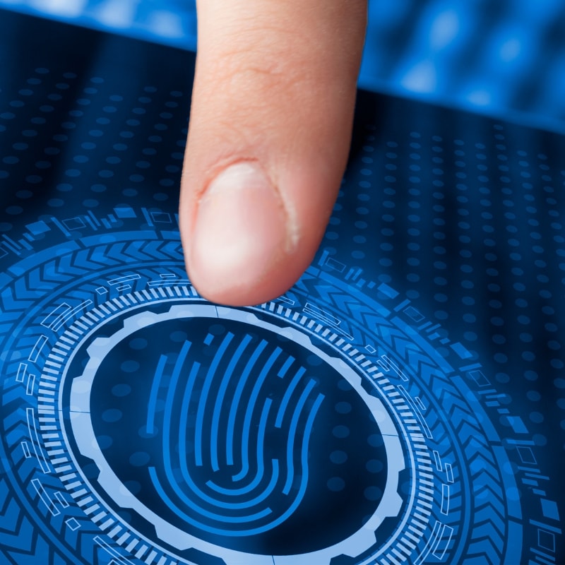 Finger touching digital fingerprint scanner on touchscreen display - EZTR Corp, Oceanside, NY