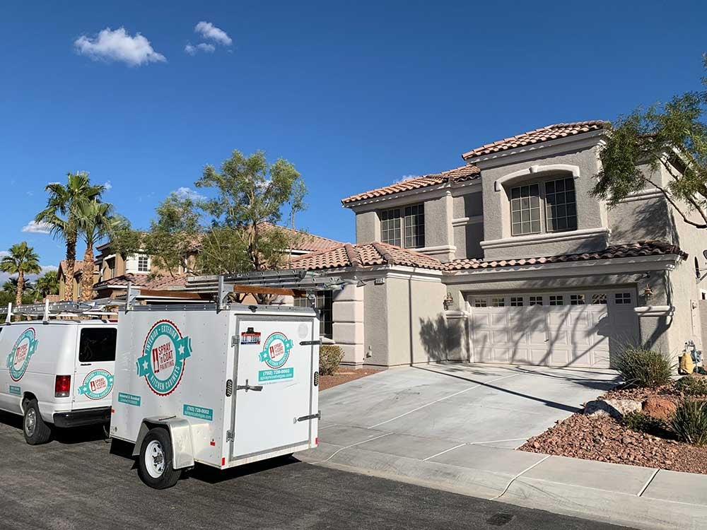 Service van with trailer parked outside residential home - Spray 'n Coat Painting, Las Vegas Metro Area