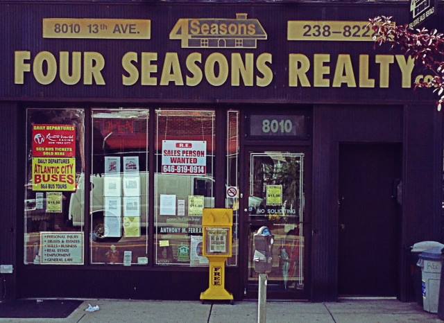Four Seasons Realty Co Real estate office storefront with signage and windows serving Brooklyn & Staten Island