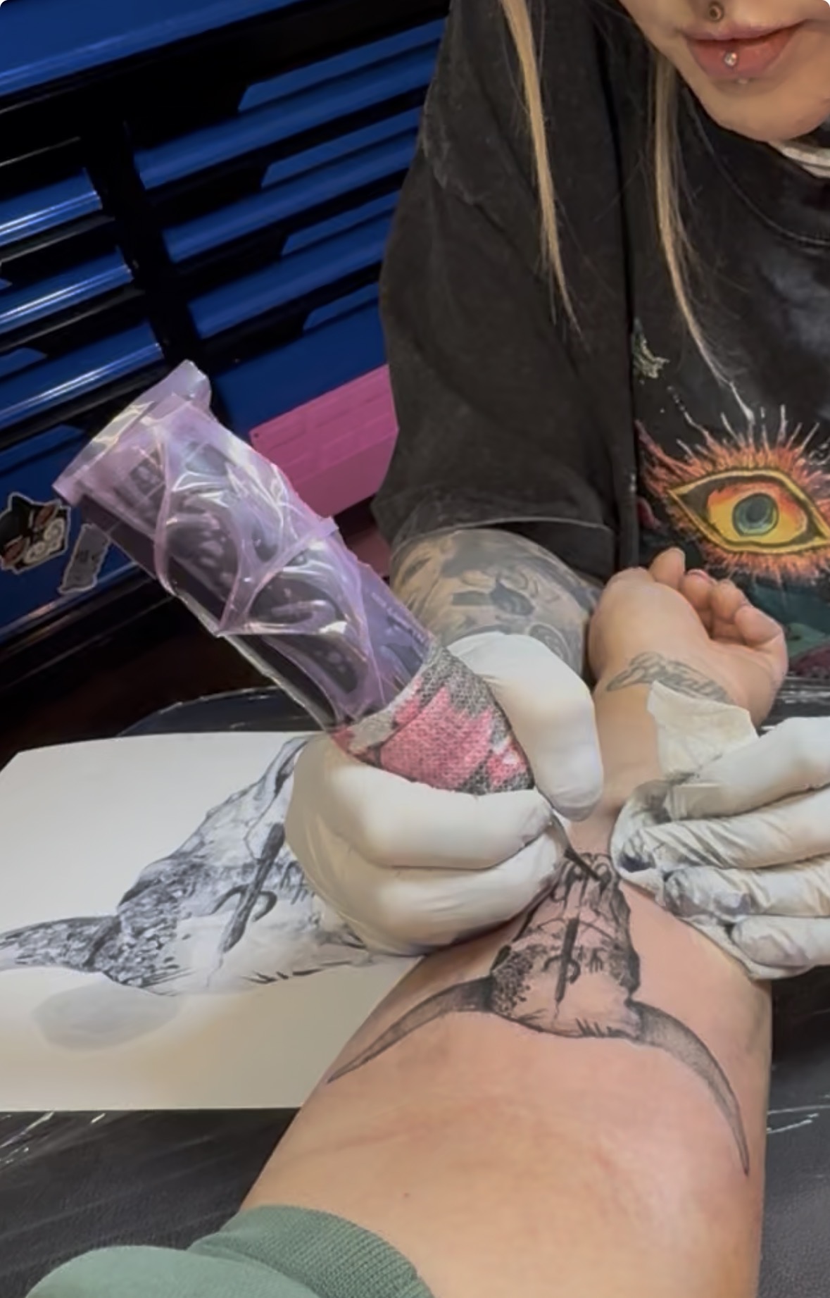 Moon Beam Chels: Tattoo artist applying fresh tattoo on client's thigh
