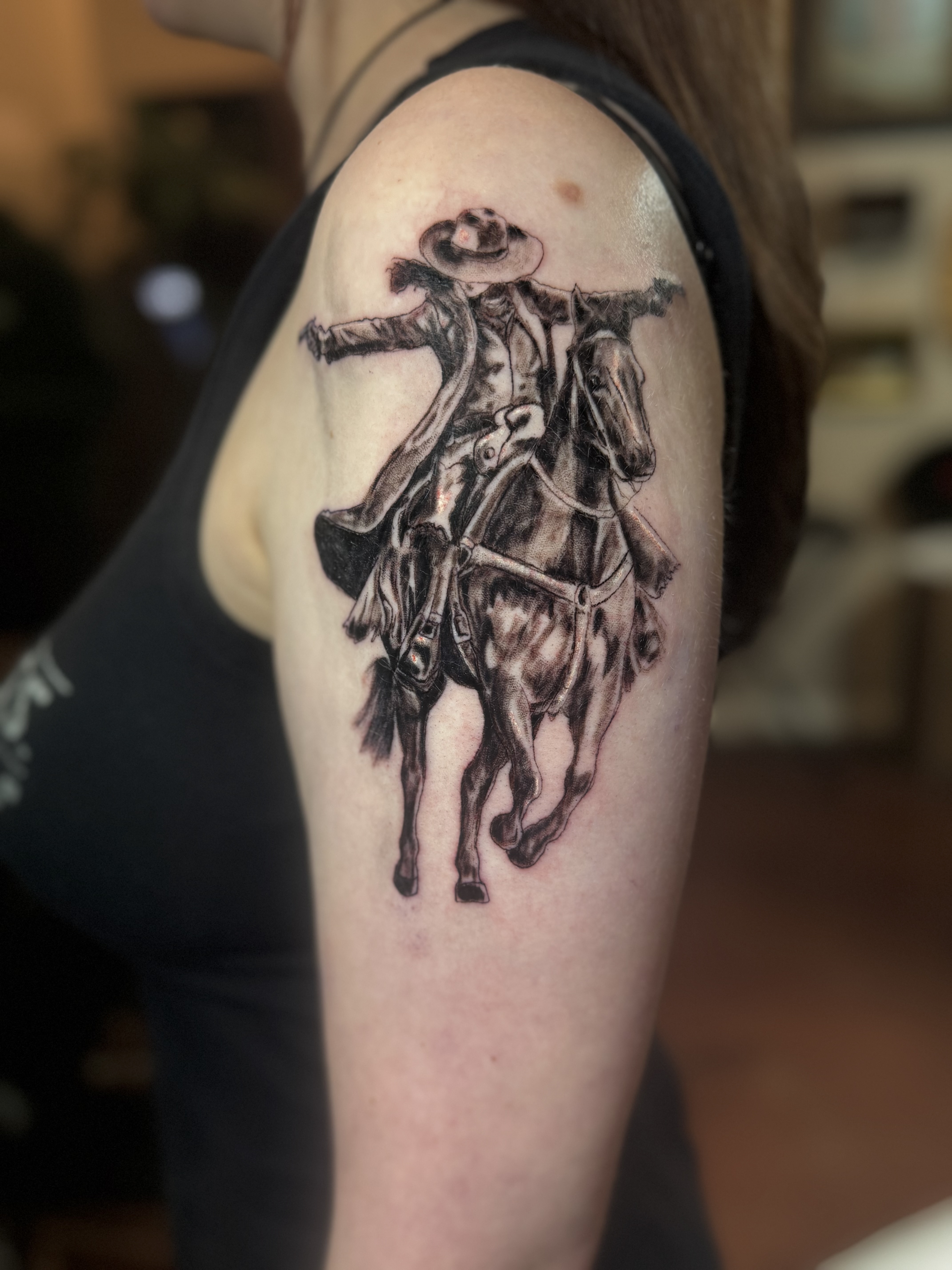 Moon Beam Chels: Finished black and gray cowboy on horse tattoo on upper arm