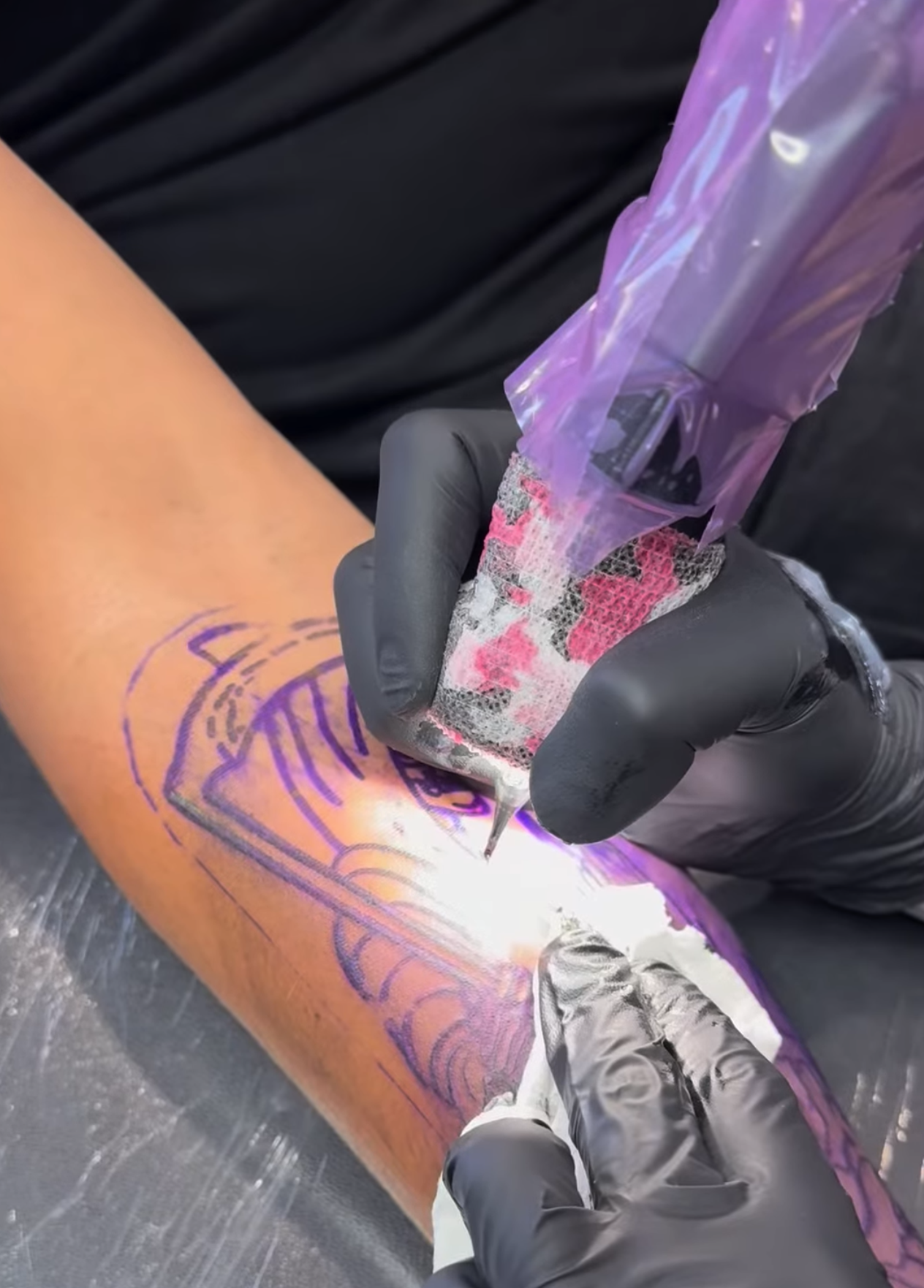 Tattoo artist applying stencil to client's forearm - Moon Beam Chels, Salt Lake City, UT