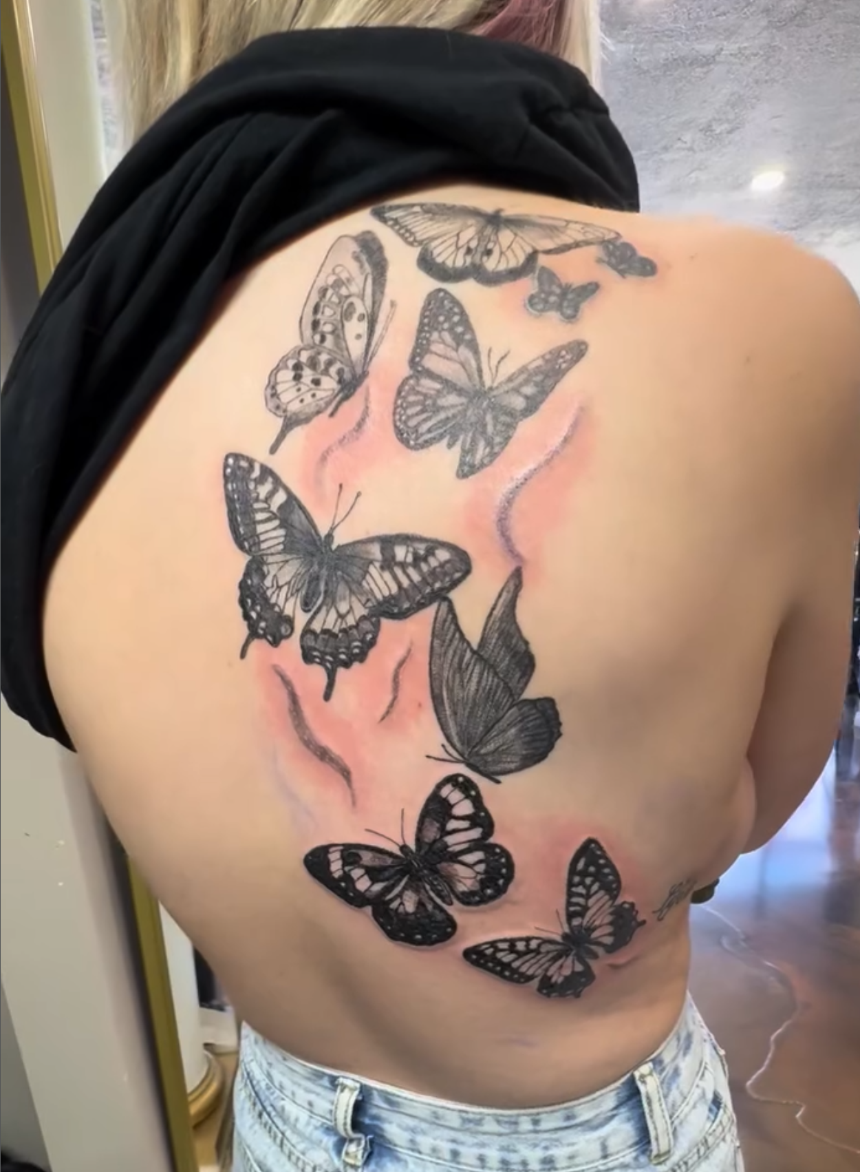 Fresh black-and-gray butterfly back tattoo on woman, recently finished - Moon Beam Chels, Salt Lake City, UT