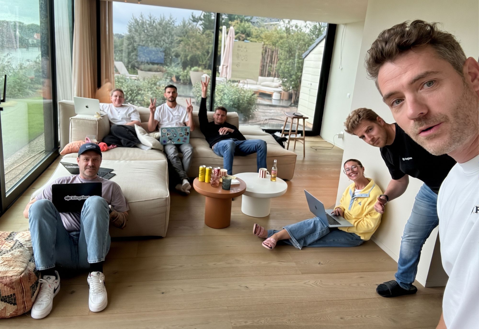 The Ringtime team working on laptops in a living room during a team offsite