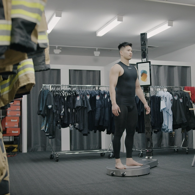 Person being measured with BODD body-scanning technology for uniform fitting