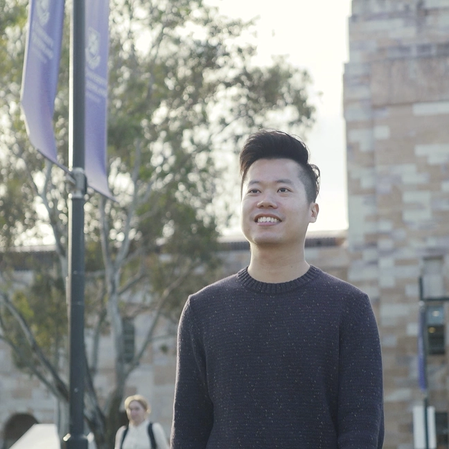 International student smiling outdoors on a Brisbane university campus