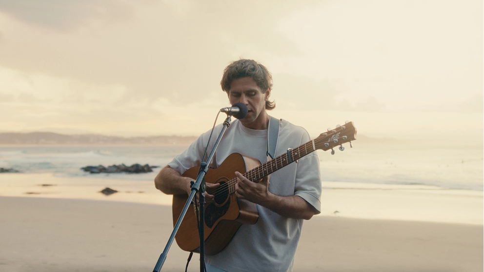 Gaudion performing “Iris” on the beach at Snapper Rocks, Gold Coast