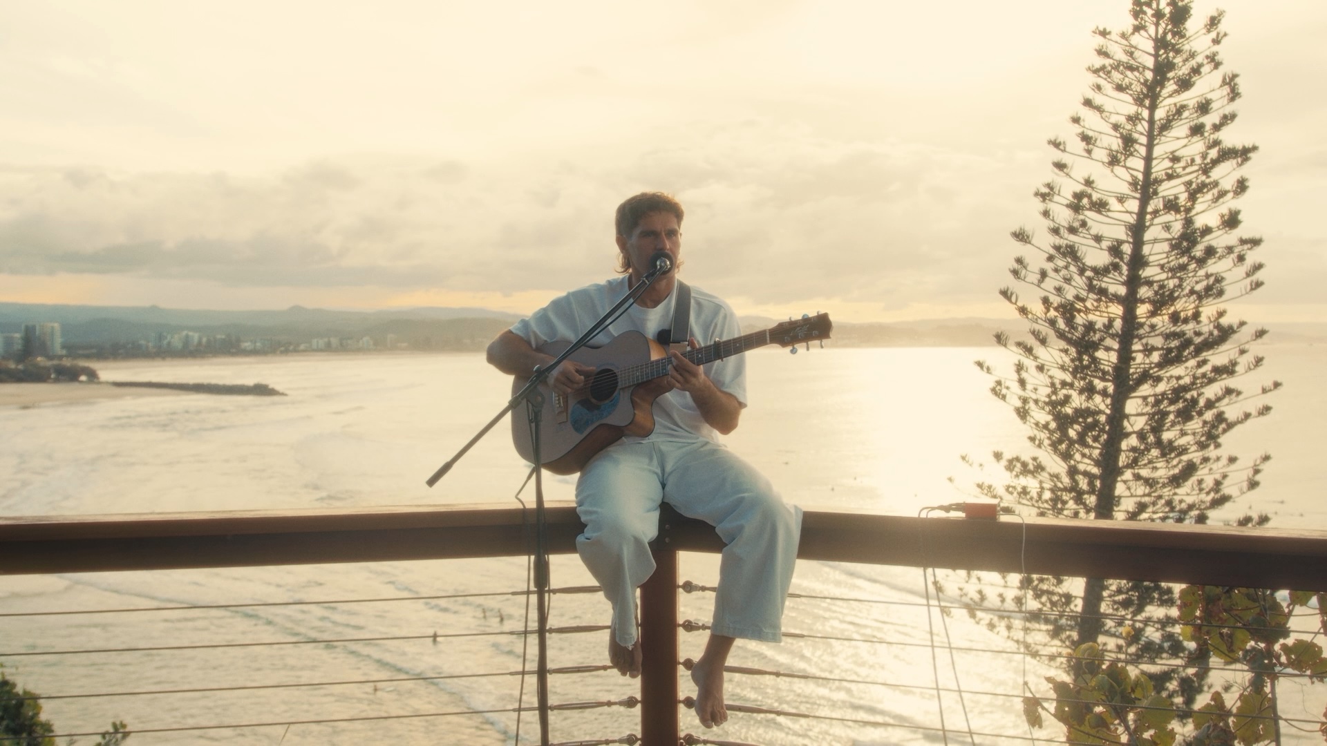 Gaudion performing “Down Under” overlooking the Gold Coast coastline