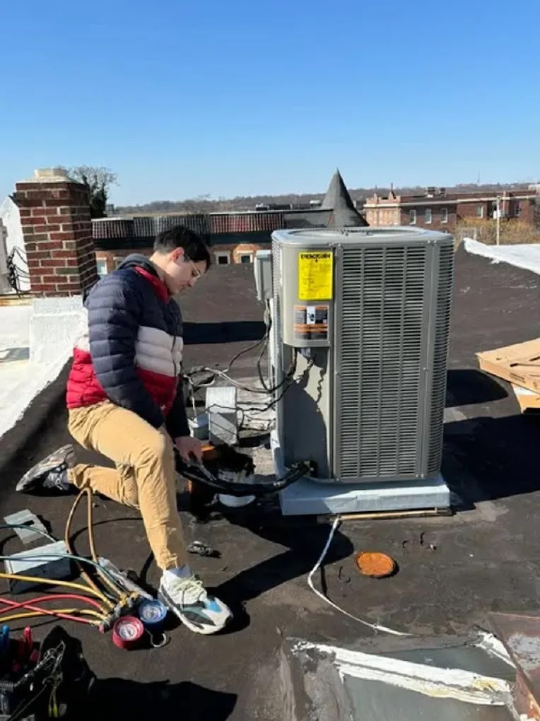 Technician performing essential steps in an effective AC tune-up, including cleaning and checking refrigerant