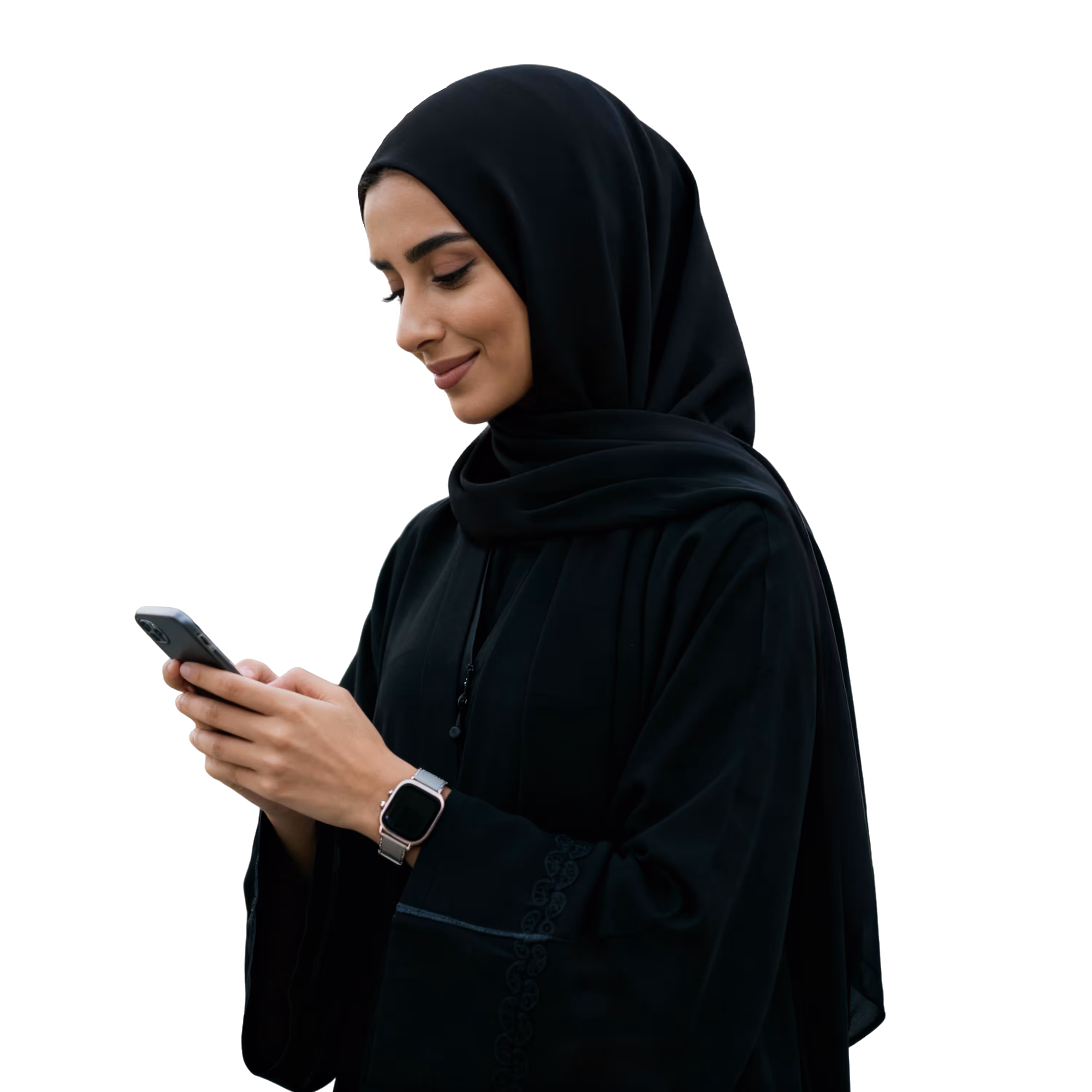 Woman wearing a black hijab and abaya looking at her smartphone and smiling.